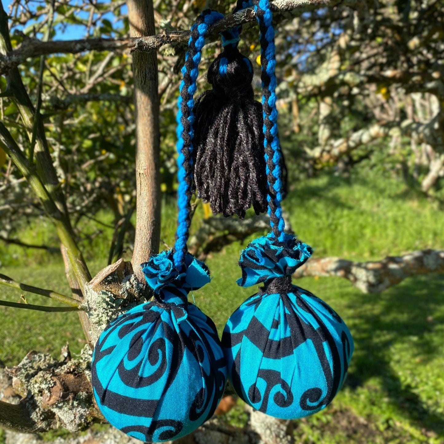Māori Poi Turquoise Koru Rakau with blue & black Braided Cord